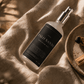Palo Santo Meditation Mist resting on linen beside Palo Santo sticks and ceramic dish.