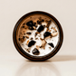 Palo Santo ritual candle with crystals Palo Santo chips, and botanical details viewed from above.