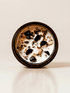 Palo Santo ritual candle with crystals Palo Santo chips, and botanical details viewed from above.