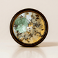 Release ritual candle with green calcite, quartz, and botanical details viewed from above.