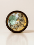Release ritual candle with green calcite, quartz, and botanical details viewed from above.