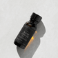 Bottle of "Road Opener" ritual oil on a light gray background.