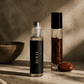 Two roller bottles with 'ROOT' on a textured surface with smoke and natural elements.