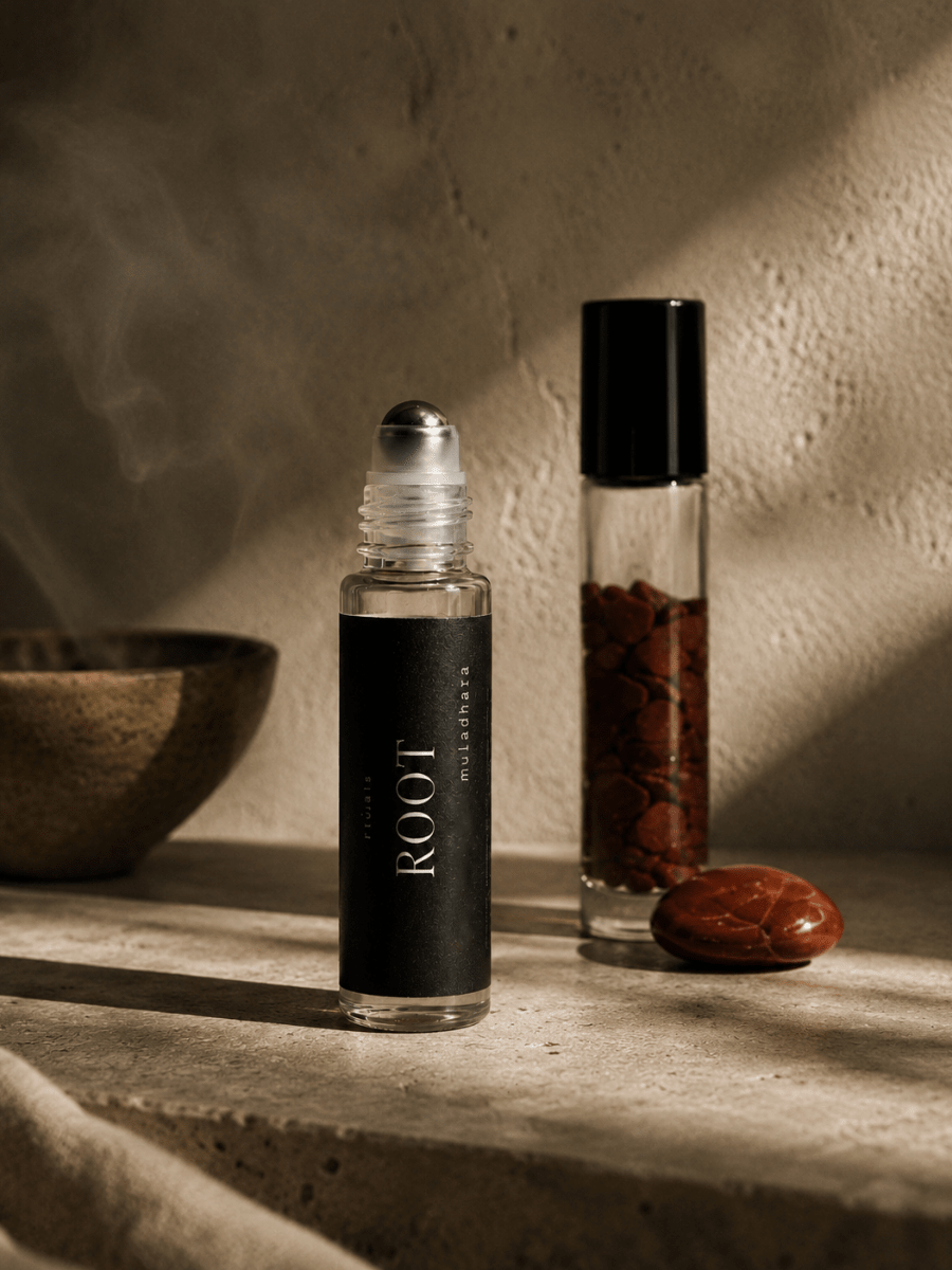 Two roller bottles with 'ROOT' on a textured surface with smoke and natural elements.