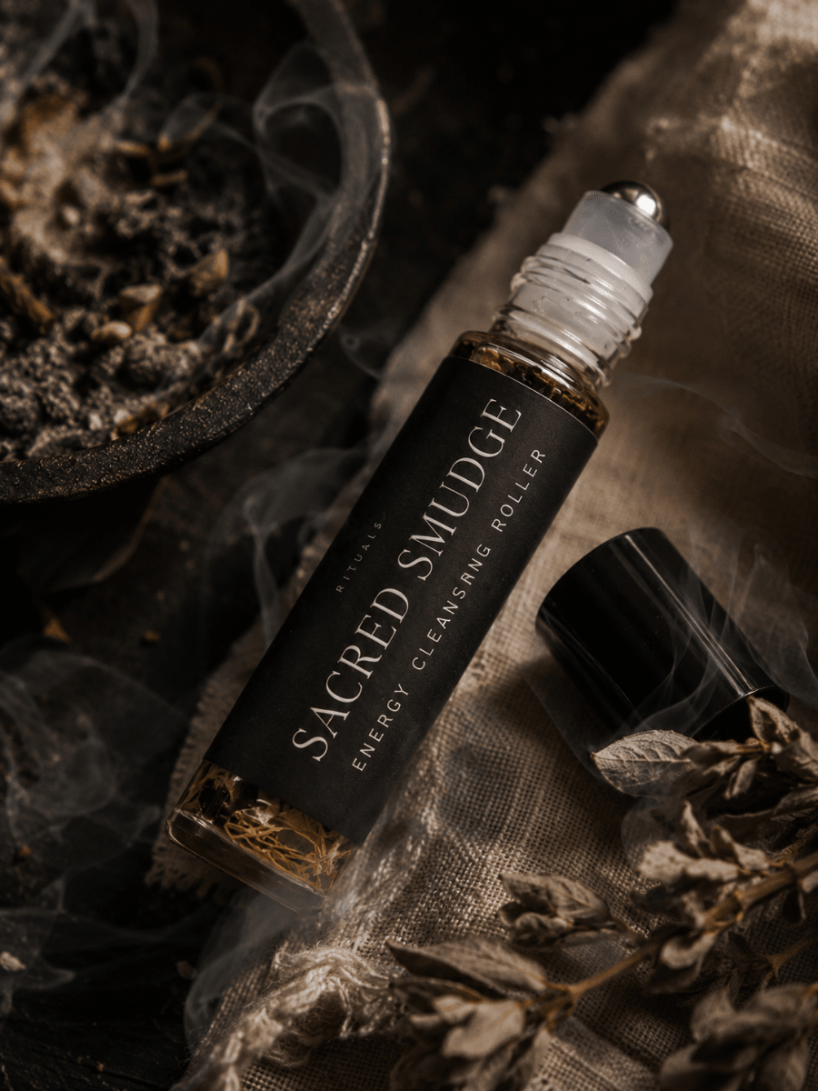 Sacred Smudge Cleansing Ritual Roller by Alchemist + Co. on a linen background with herbs and botanicals.
