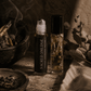 Two roller bottles with herbs and botanicals labeled Sacred Smudge by Alchemist + Co.