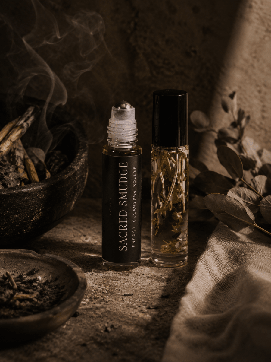 Two roller bottles with herbs and botanicals labeled Sacred Smudge by Alchemist + Co.