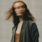 A Sagittarius woman in motion against a neutral background.