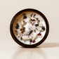 Self Love ritual candle with rose quartz, moonstone, garnet, and botanical details viewed from above.
