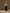 Bottle of 'Smudge' meditation mist on a wooden surface with a blurred background.