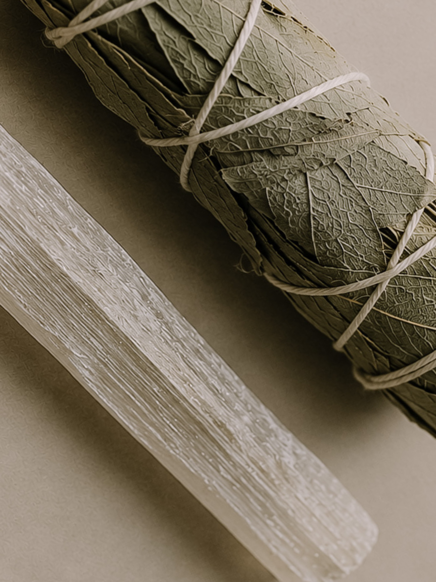 Bundled sage leaves tied with twine on a neutral background.