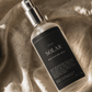 Solar Meditation Mist resting on textured linen fabric with soft natural shadows.