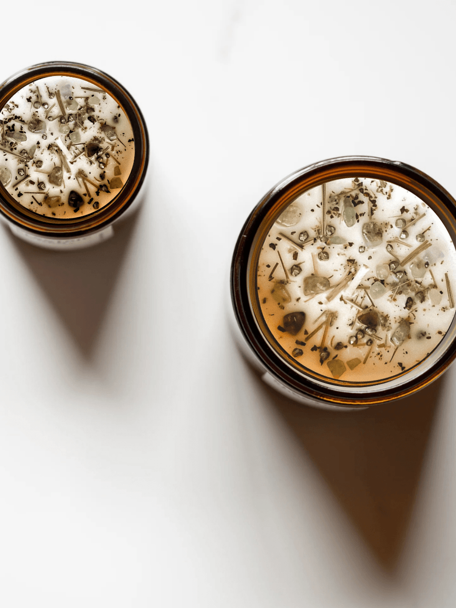 Top views of The Fool ritual candle with peridot, rainforest rhyolite, rutilated quartz, and botanicals.