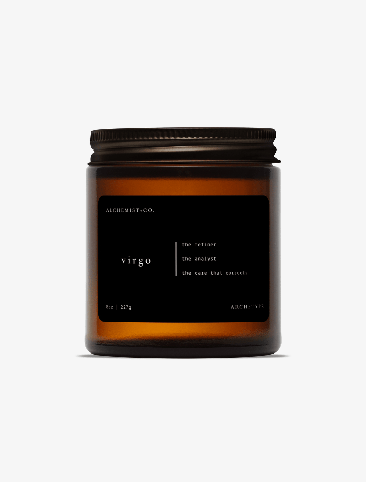 Virgo scented candle by Alchemist + Co. in an amber glass jar with a black label