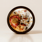 XIX. The Sun ritual candle with carnelian, rainforest rhyolite, citrine, quartz, and botanical details viewed from above.